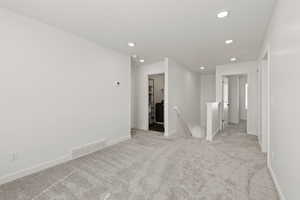 Second floor loft/living room space featuring carpet flooring and a south facing window
