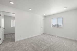 Second floor loft/living room space featuring carpet flooring and a south facing window