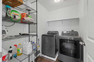 Spacious laundry room featuring LVP flooring and shelving for storage