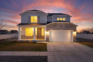 View of front of home with a rock and siding exterior, and a covered front porch