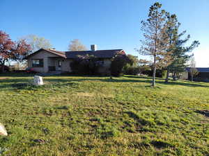 View of front of house featuring a front yard and brick siding