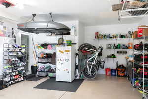 Garage featuring freestanding refrigerator