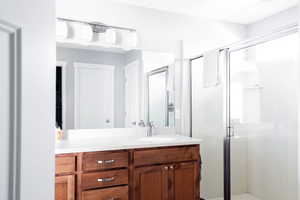 Bathroom featuring vanity and a shower stall