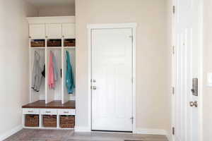 Mudroom with baseboards and light wood-type flooring