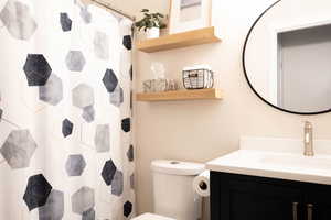 Full bathroom with vanity and curtained shower