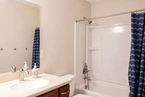 Full bath with vanity and shower / bath combo with shower curtain