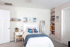 Bedroom featuring light carpet and baseboards
