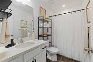 Bathroom featuring vanity and dark wood-style flooring