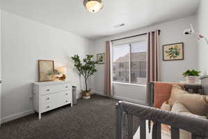 Bedroom with baseboards and dark carpet