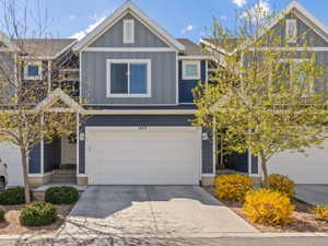 Craftsman-style home with board and batten siding, concrete driveway, and a garage