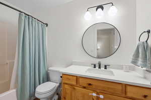 Bathroom with vanity and shower / bathtub combination with curtain