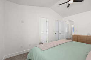 Carpeted bedroom with baseboards and ceiling fan