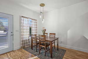 Dining room with light wood-type flooring and baseboards