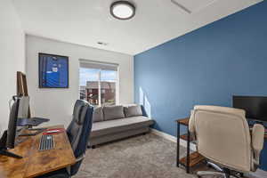 Carpeted office space with baseboards