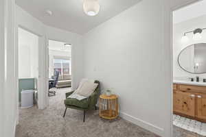 Sitting room featuring light carpet and baseboards