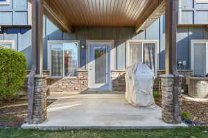 Doorway to property with stone siding