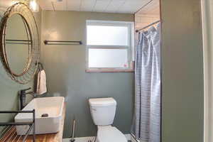 Bathroom with toilet and a stall shower