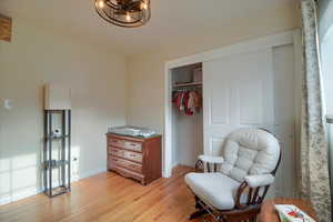 Living area with light wood-style flooring and baseboards