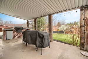 Fenced backyard with grilling area and a patio