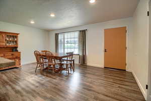 Dining room with recessed lighting and dark wood-type flooring
