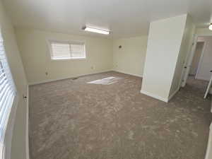 Carpeted primary bedroom with baseboards