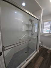 Primary Full bath featuring dark wood-style flooring, a shower stall, and recessed lighting