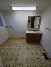 Bathroom with vanity and laundry area