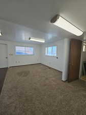 Family room featuring dark carpet and baseboards and walk out entrance to separate driveway