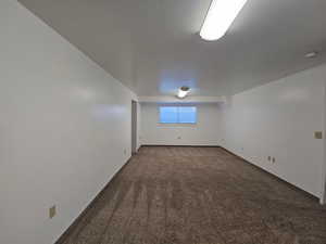 East side bedroom featuring dark carpet