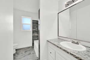 Full bath featuring toilet and vanity