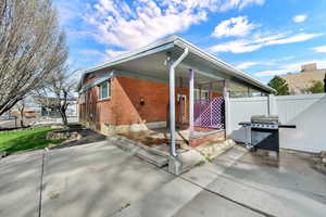 View of home's exterior featuring a patio area and brick siding