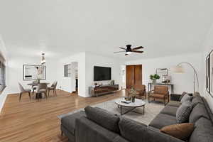 Living area with wood finished floors and ceiling fan