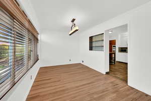 Unfurnished dining area featuring crown molding and wood finished floors