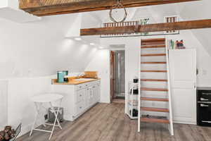 Interior space with wood finished floors, recessed lighting, and a high ceiling