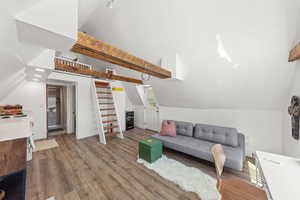 Living area featuring vaulted ceiling and wood finished floors