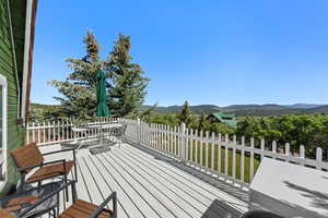 Wooden terrace with a mountain view and outdoor dining area