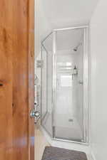 Bathroom featuring a stall shower and light tile patterned flooring