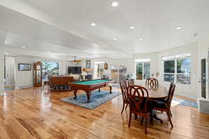 Game room with billiards, light wood-style floors, a textured ceiling, recessed lighting, and a ceiling fan
