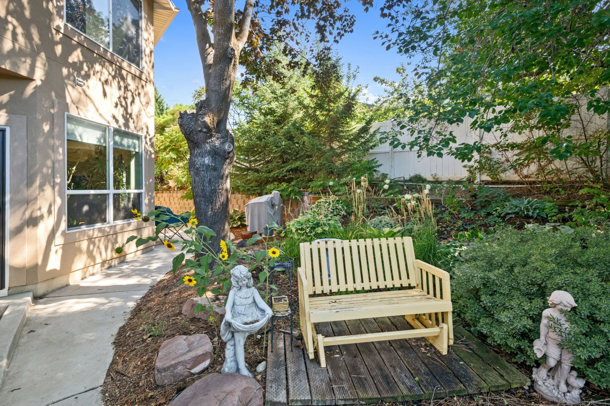 Wooden terrace with a fenced backyard