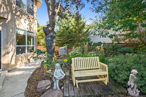 Wooden terrace with a fenced backyard