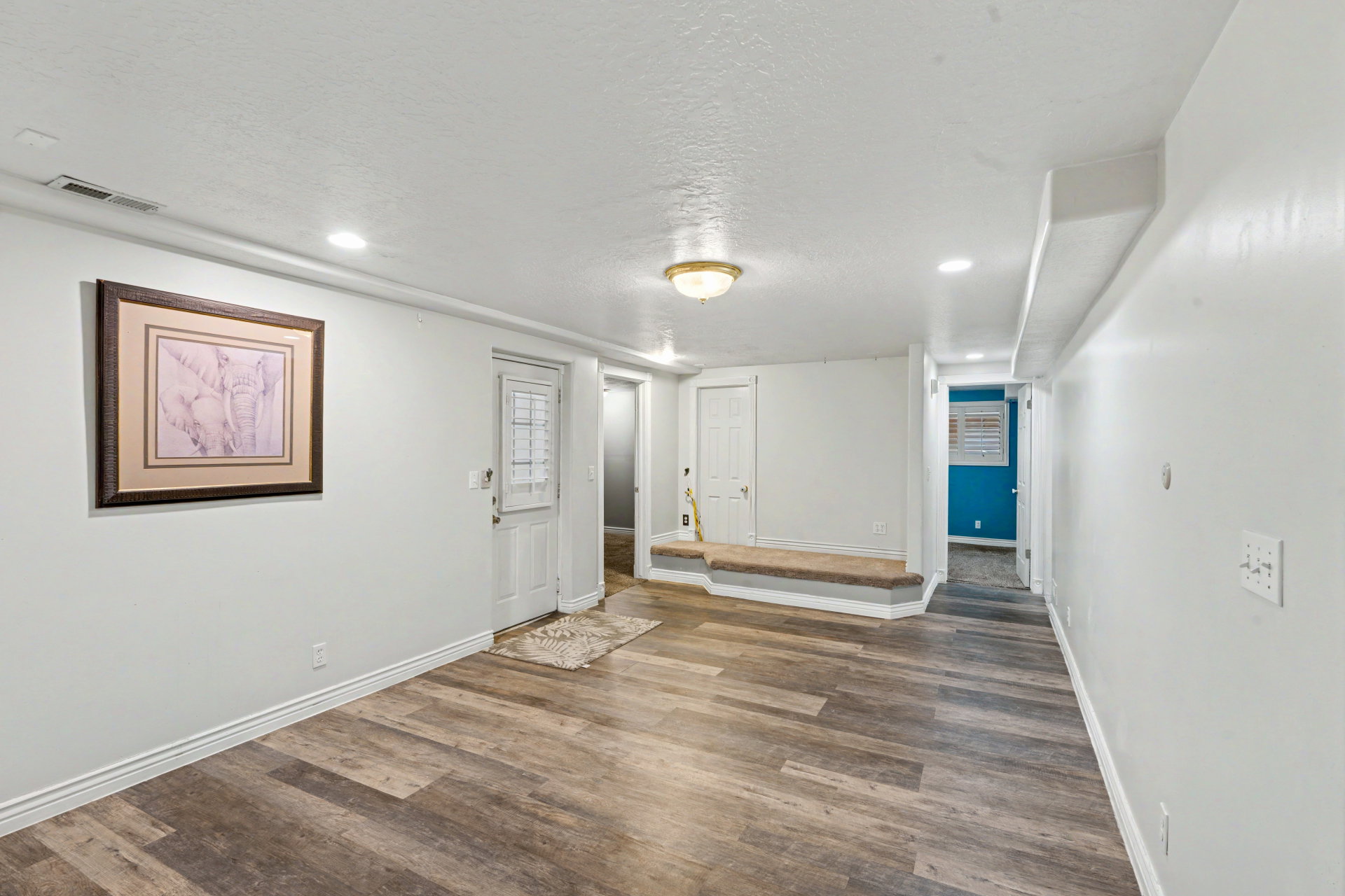 Unfurnished dining with a textured ceiling, dark wood-type flooring, and recessed lighting