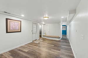 Unfurnished dining with a textured ceiling, dark wood-type flooring, and recessed lighting