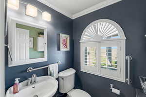 Main floor Bathroom with ornamental molding and a textured ceiling