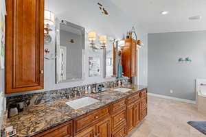 Full bath with double vanity and a bath