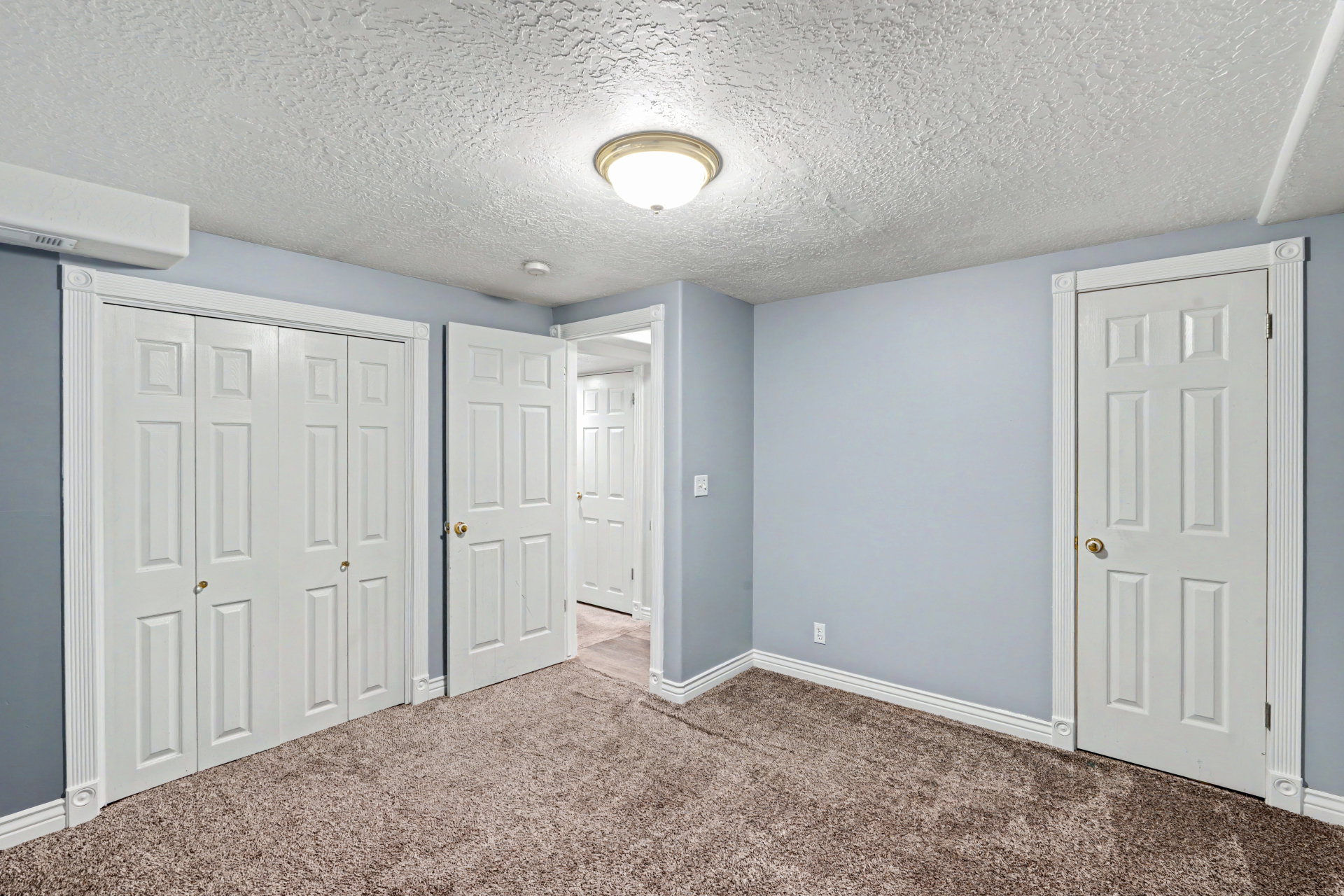 Unfurnished bedroom with a textured ceiling, carpet flooring, and a closet