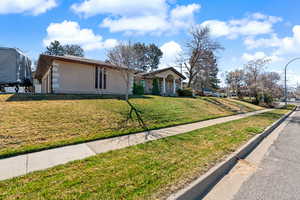 View of front of home with a front lawn and brick siding