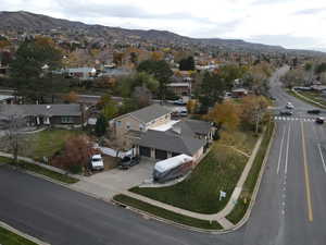 Aerial overview of property's location featuring a mountainous background and nearby suburban area