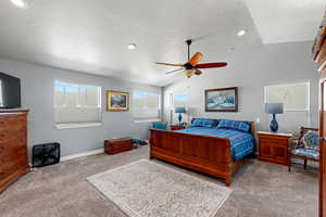 Bedroom featuring light carpet, ceiling fan, and recessed lighting