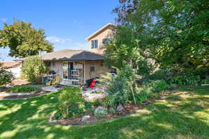 Back of house featuring brick siding