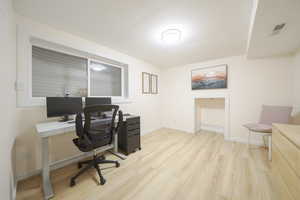 Office area featuring light wood-type flooring and baseboards